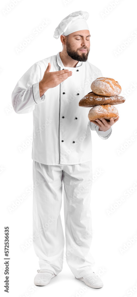 Male baker with loaves of fresh bread on white background