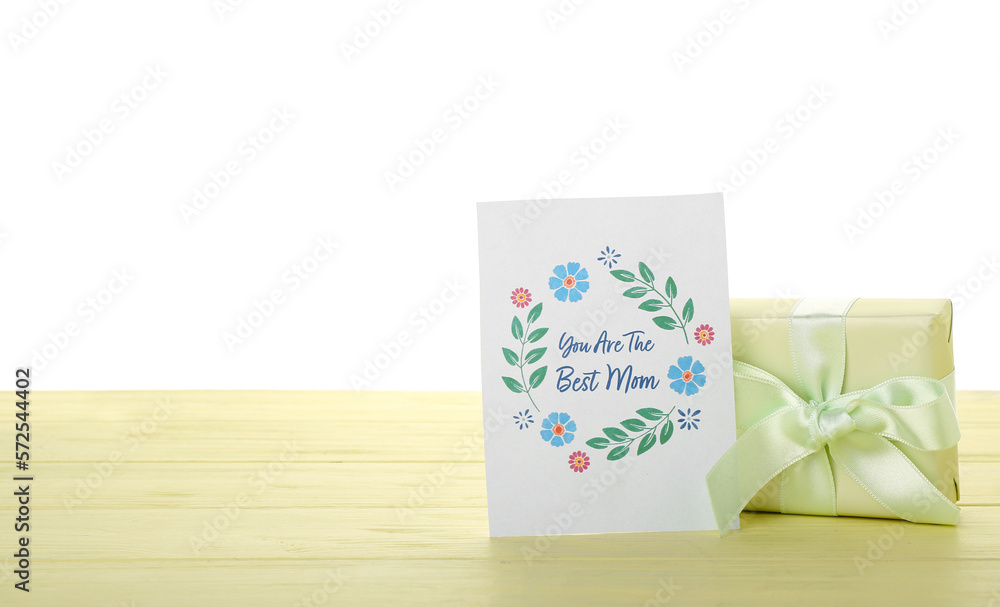 Greeting card for Mothers Day and gift on table against white background