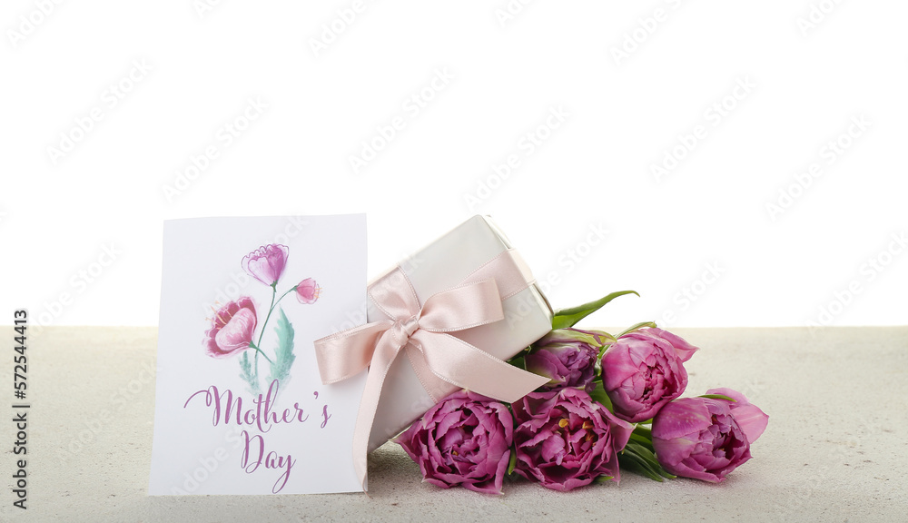 Greeting card with text MOTHERS DAY, tulips and gift on table against white background