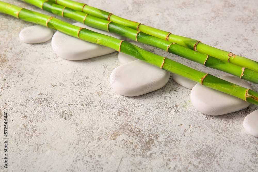 Spa stones and bamboo on light background