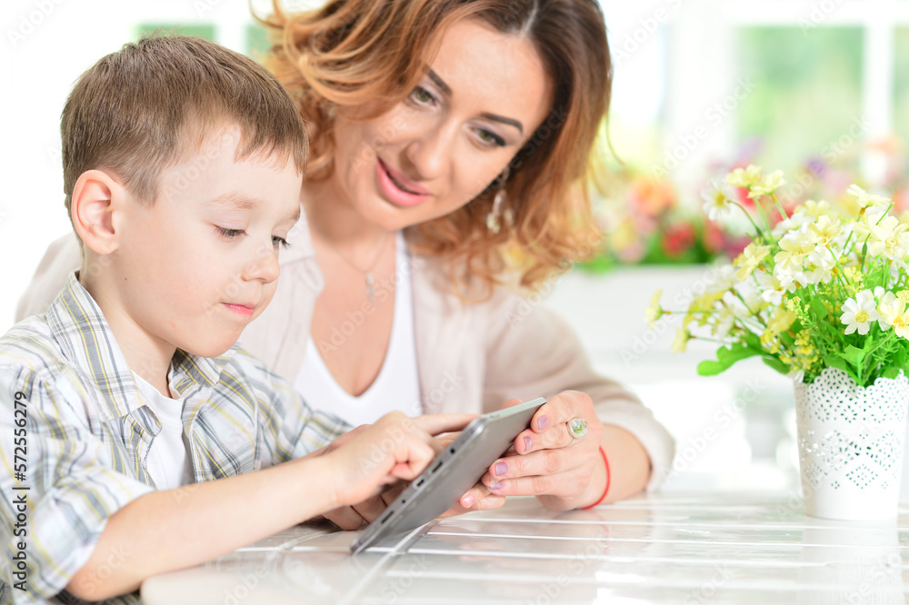 Mother and son using tablet computer