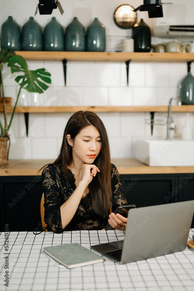 Asian businesswoman working in the home office with working notepad, tablet and laptop documents in 