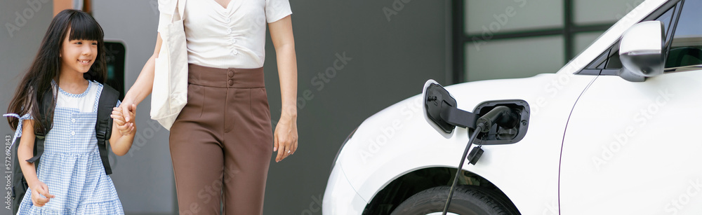 Progressive lifestyle of mother and daughter who have just returned from school in an electric vehic