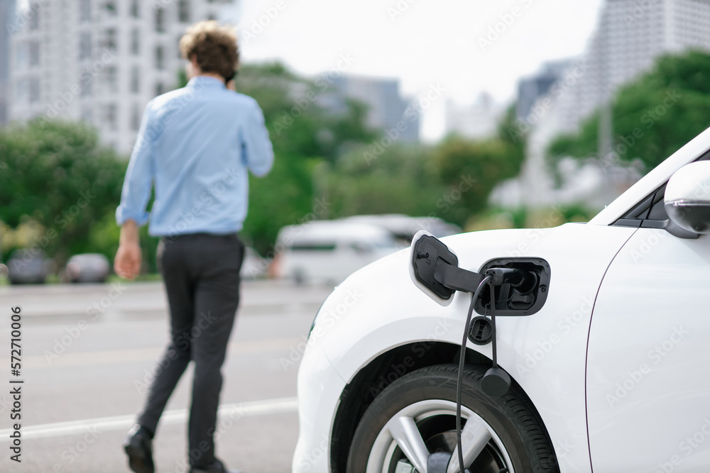 Progressive eco-friendly concept of focus parking EV car at public electric-powered charging station