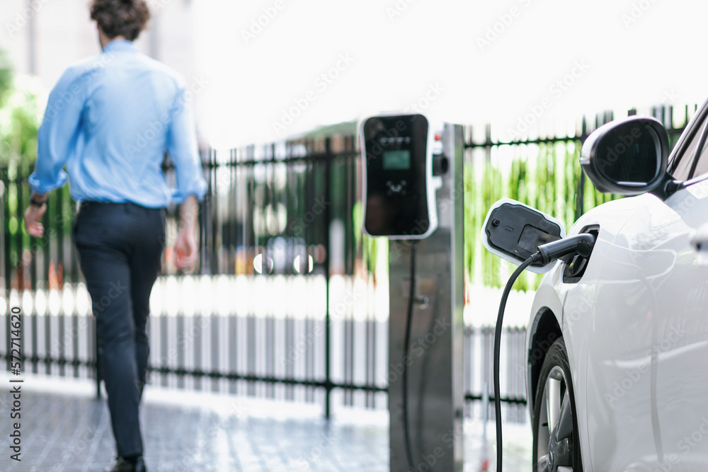 Progressive eco-friendly concept of focus parking EV car at public electric-powered charging station