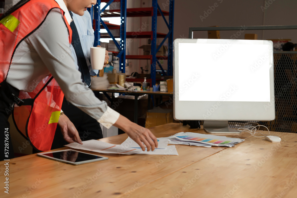 Computer with green screen display in warehouse storage room . Delivery and transportation software 