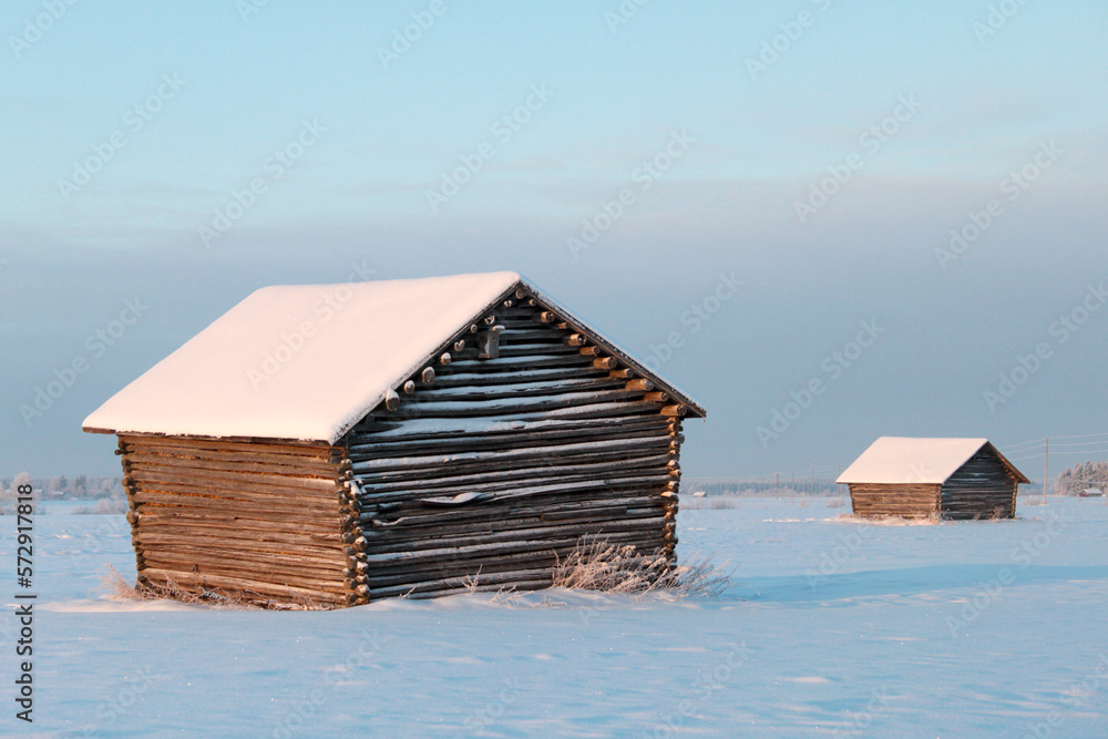 Old Barn on a Snowy Field in Winter