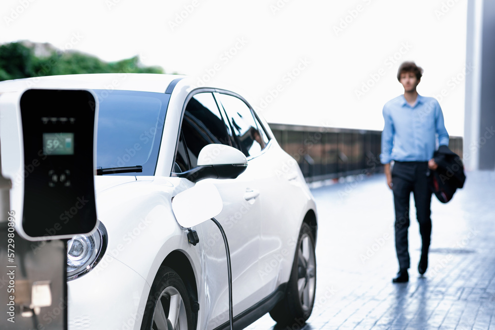 Progressive eco-friendly concept of focus parking EV car at public electric-powered charging station