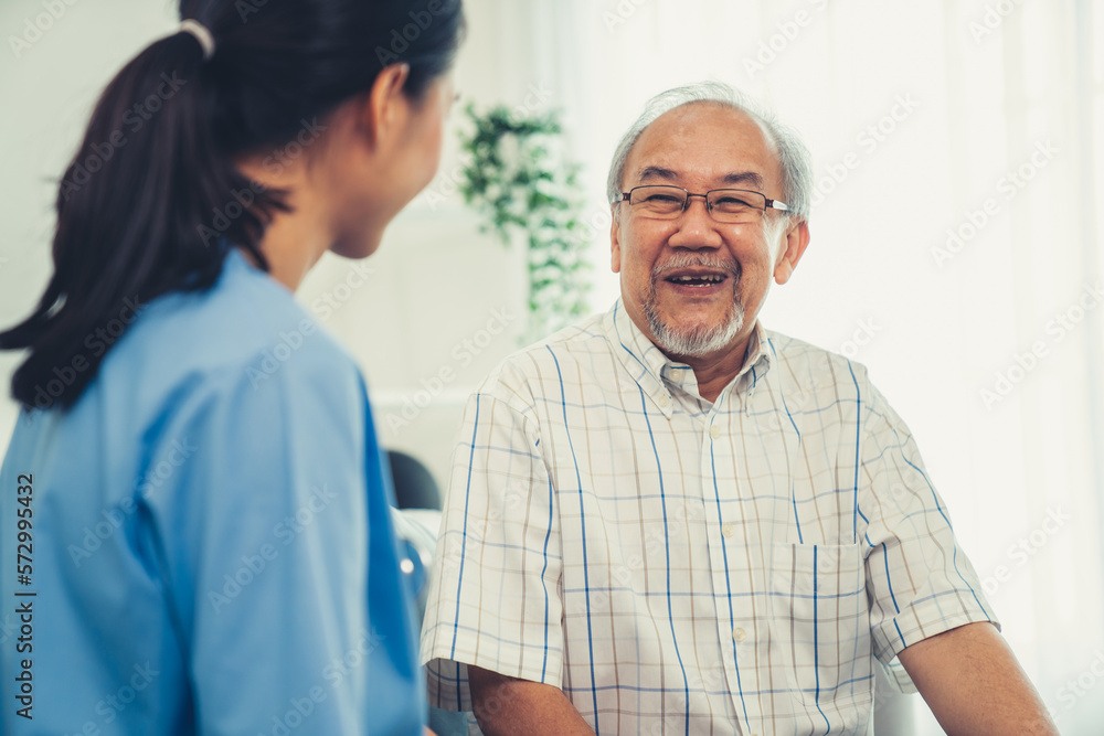 A young female doctor inquires about personal information of a contented senior at home. Medical car