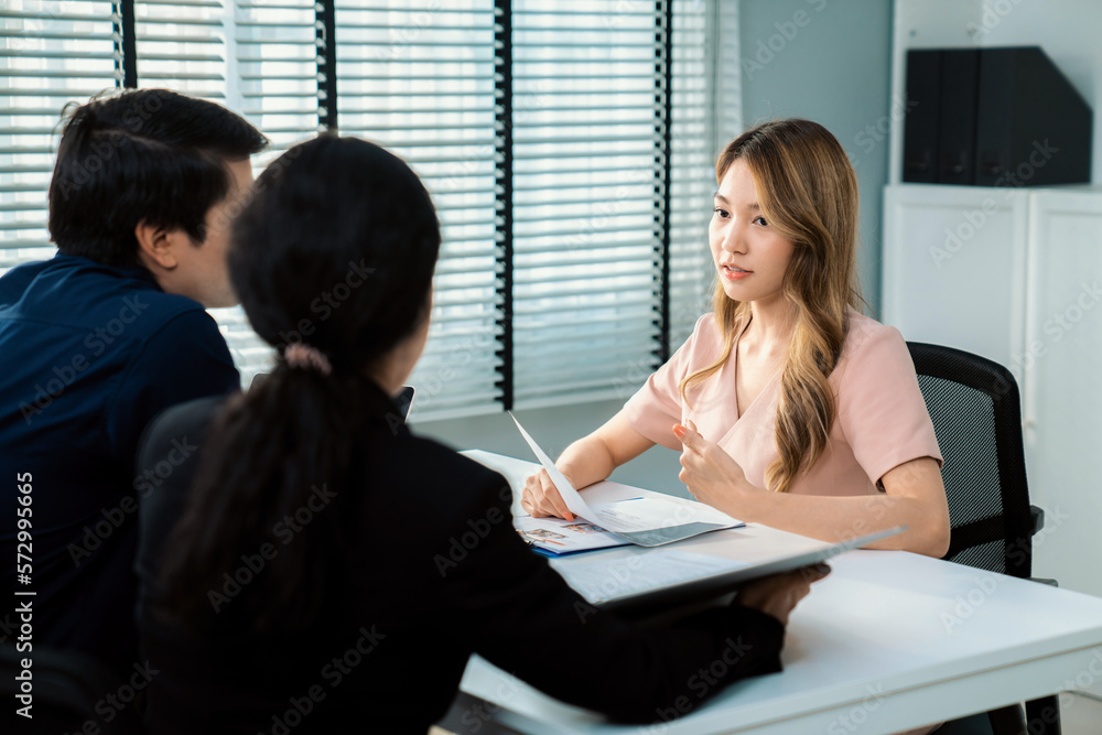 A young female asian candidate tries to impress her interviewer by being competent. International co