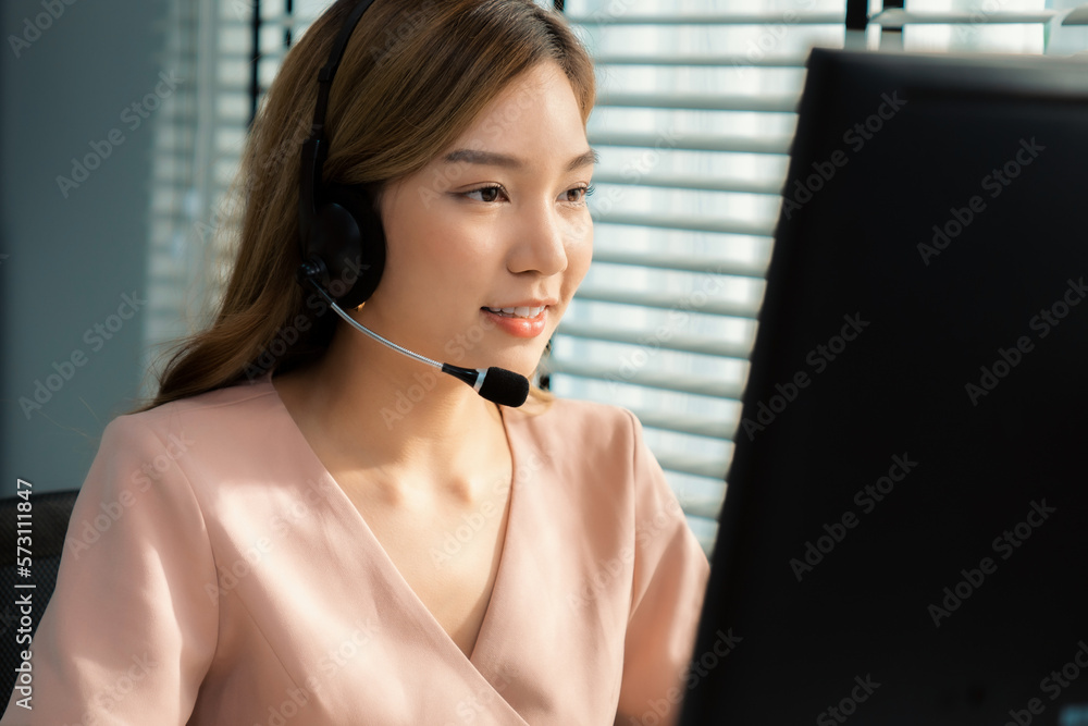 Competent female operator working on computer and while talking with clients. Concept relevant to bo