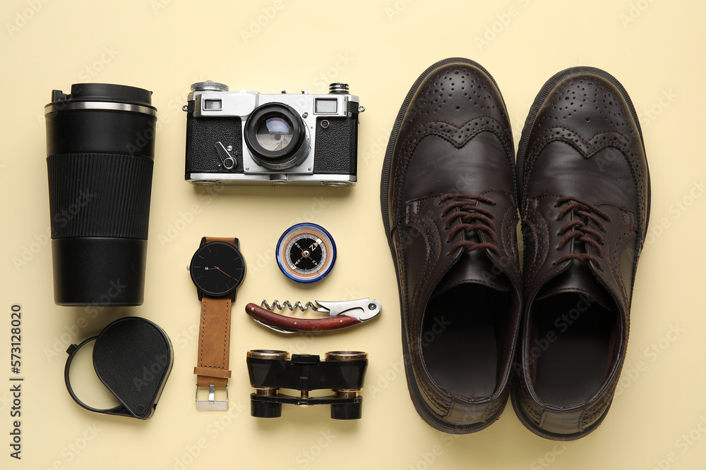 Compass with traveler accessories on beige background