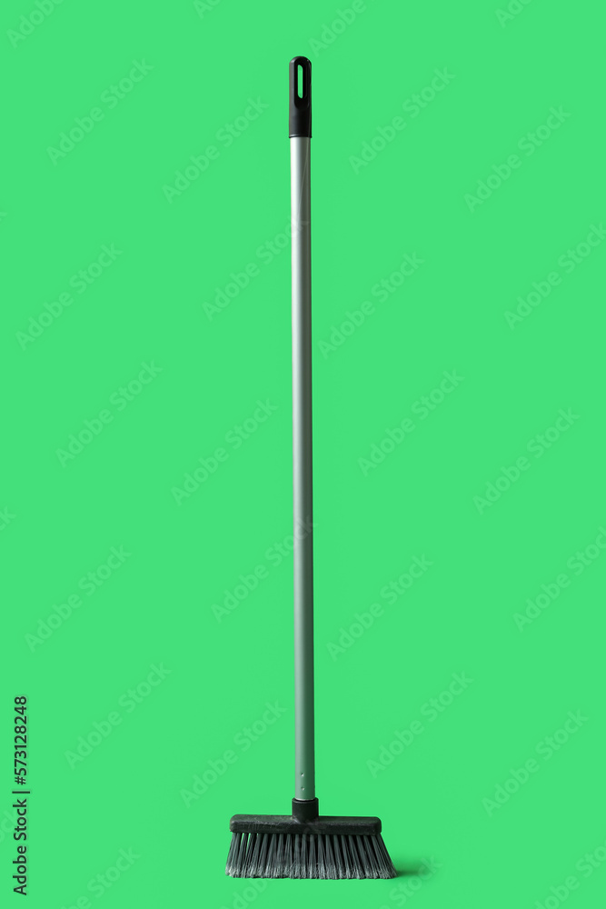 Cleaning broom on green background