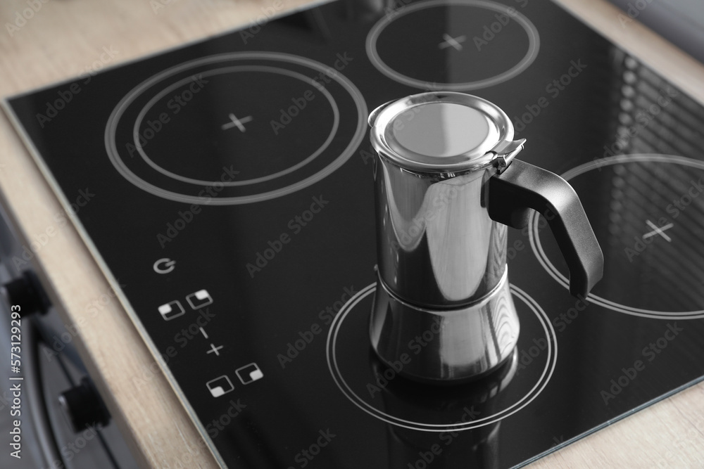 Geyser coffee maker on electric stove in kitchen