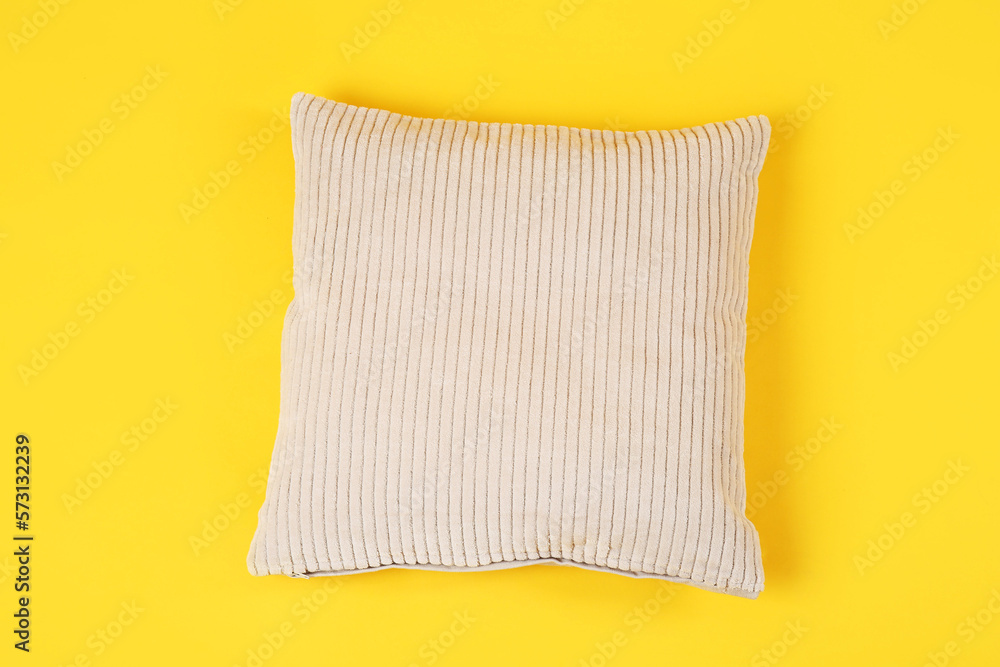 Soft pillow on yellow background