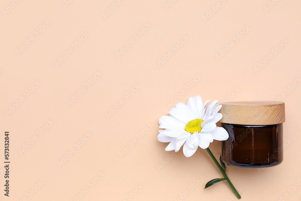 Jar of cosmetic product and chamomile flower on color background