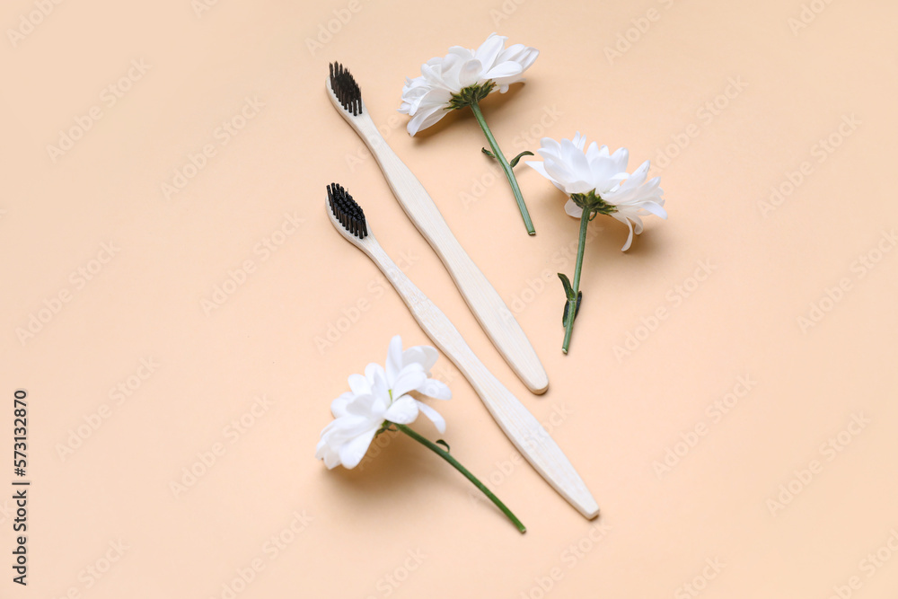 Composition with toothbrushes and chamomile flowers on color background