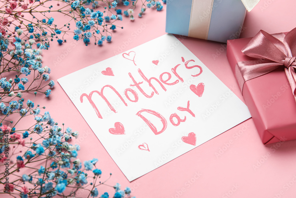 Card with text MOTHERS DAY, gypsophila flowers and gifts on pink background, closeup