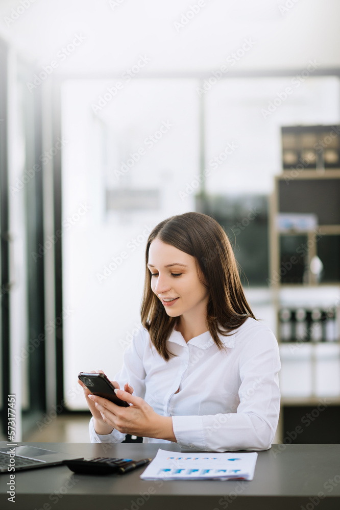 Young attractive Asian woman smiling thinking planning writing in notebook, tablet and laptop workin