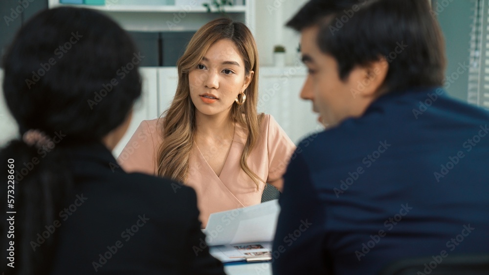 A young female asian candidate tries to impress her interviewer by being competent. International co