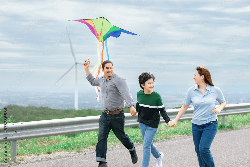 Progressive happy carefree family vacation concept. Young parents mother father and son run along an