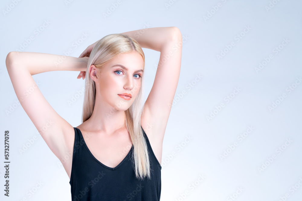 Personable woman lifting her armpit showing hairless hygiene underarm as beauty posing for cleanline