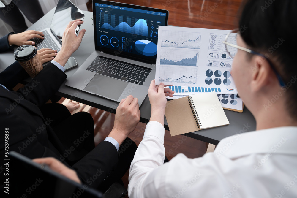 Closeup on meeting desk with businesspeople analyzing business marketing strategy with hands working