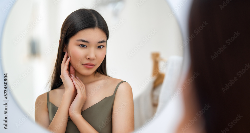 woman looking at mirror