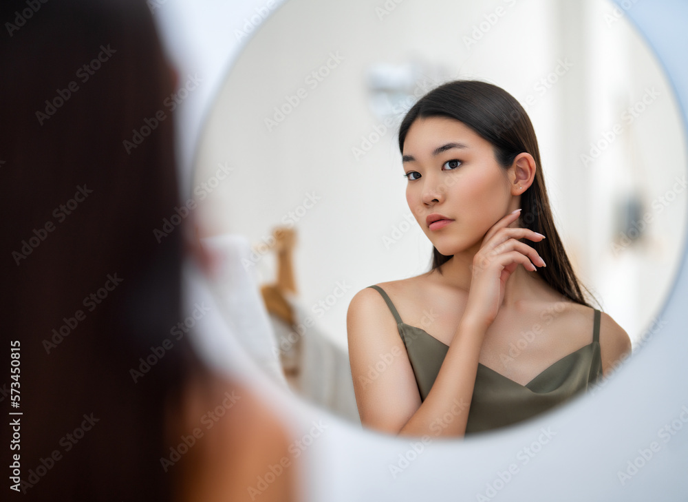 woman looking at mirror