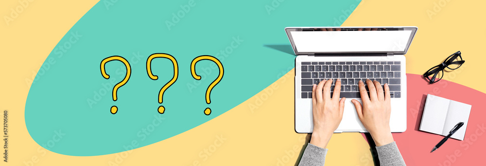 Question marks with person using a laptop computer