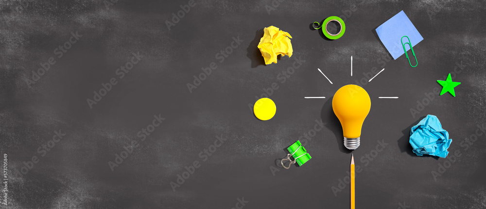 Brainstorming concept with a light bulb and school supplies