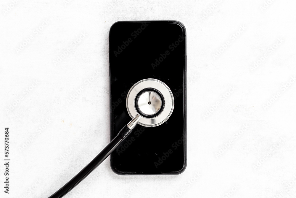 Electronics repair servise concept - mobile phone with stethoscope