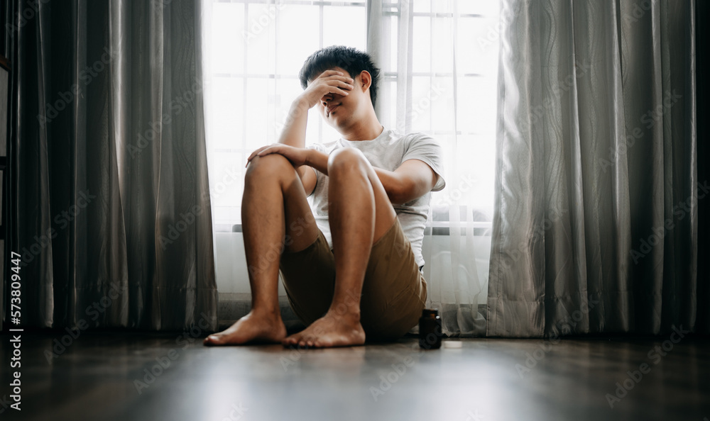 Asian Man sit Depression Dark haired  pensive glance Standing by window and anxiety Copy space.