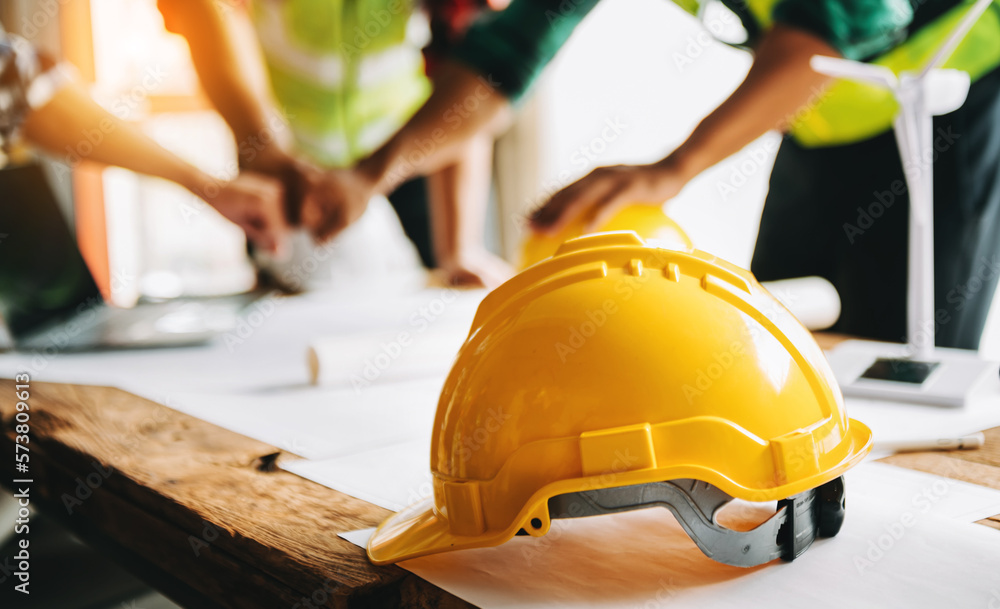 Engineer teams meeting working together wear worker helmets hardhat on construction site in modern c