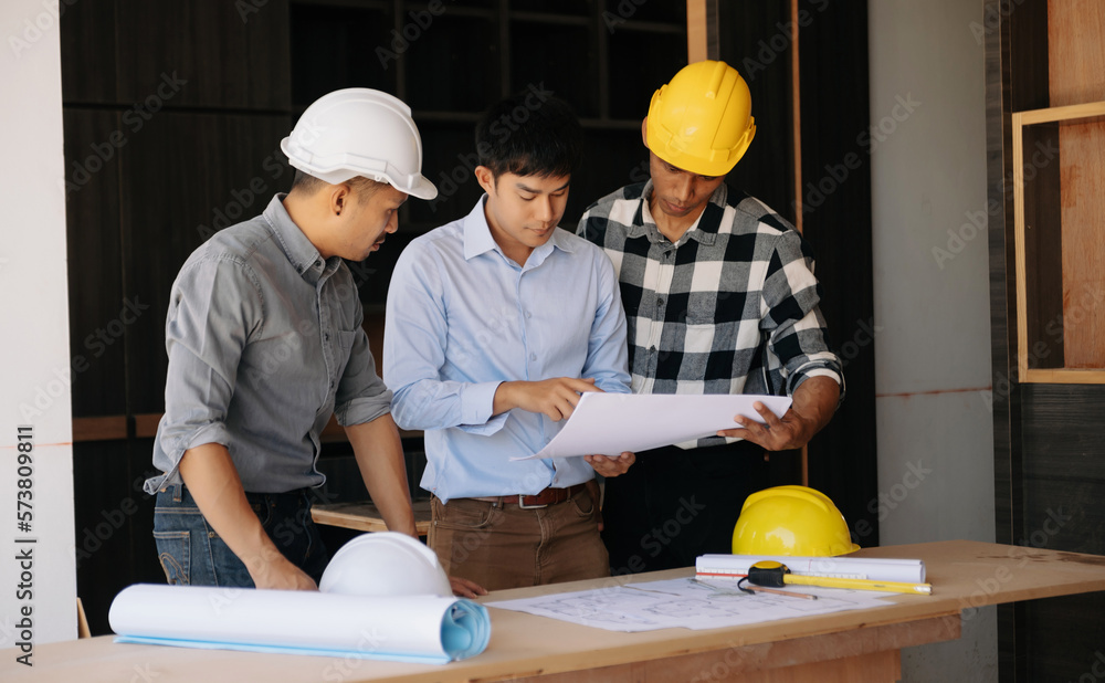 Handsome young man team architect on a building industry construction site in son light