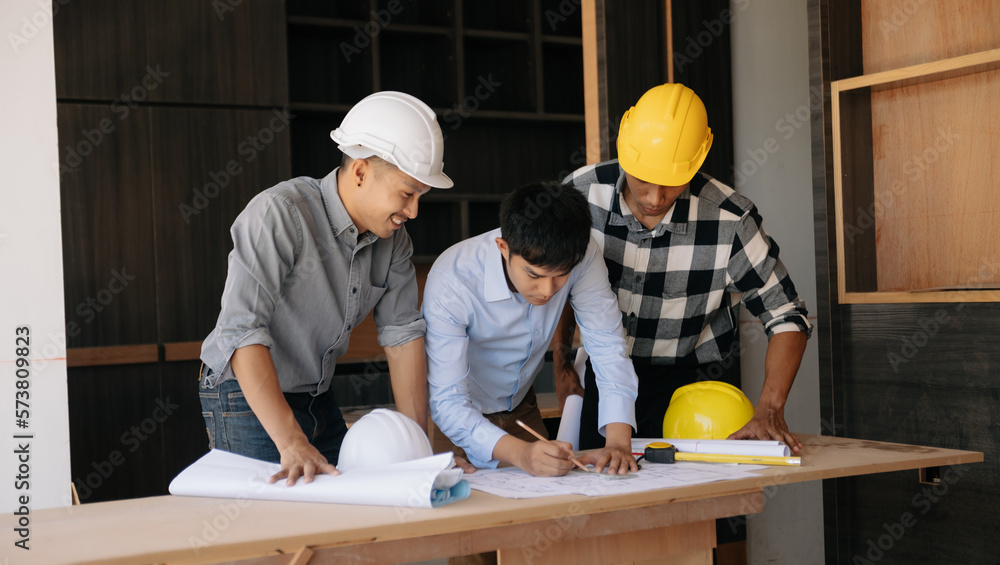 Handsome young man team architect on a building industry construction site in son light