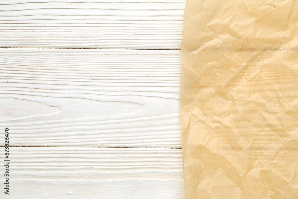 Sheet of baking paper on light wooden background