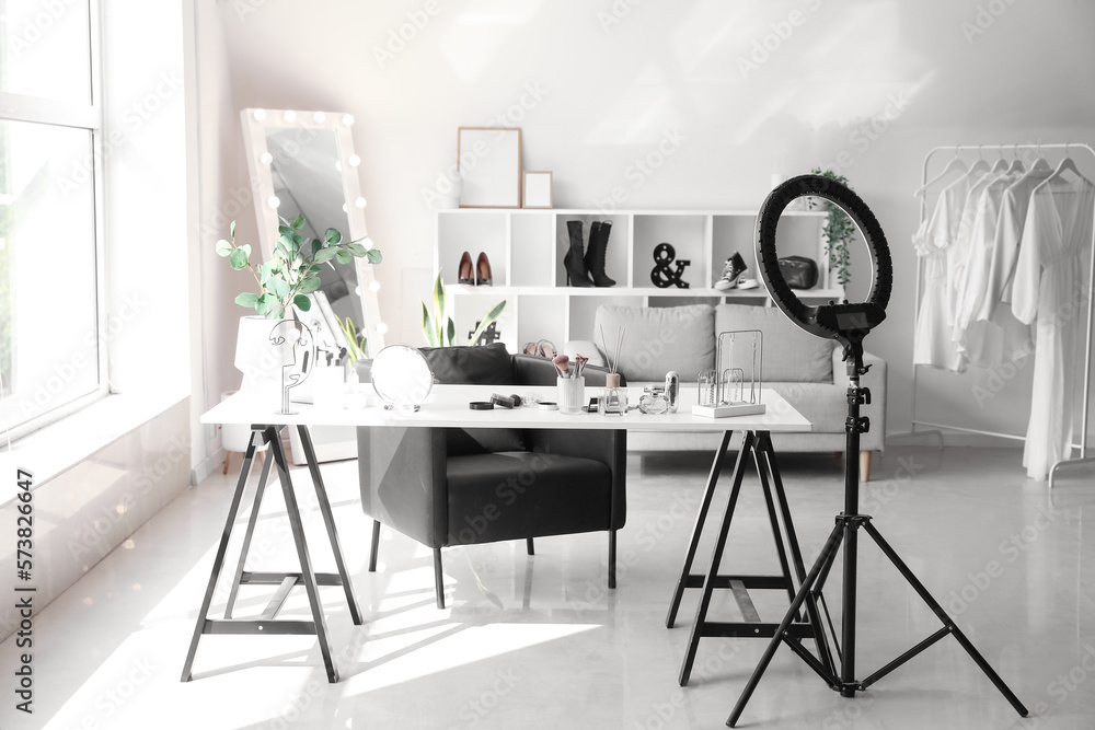 Interior of modern makeup room with table, mirror and ring light