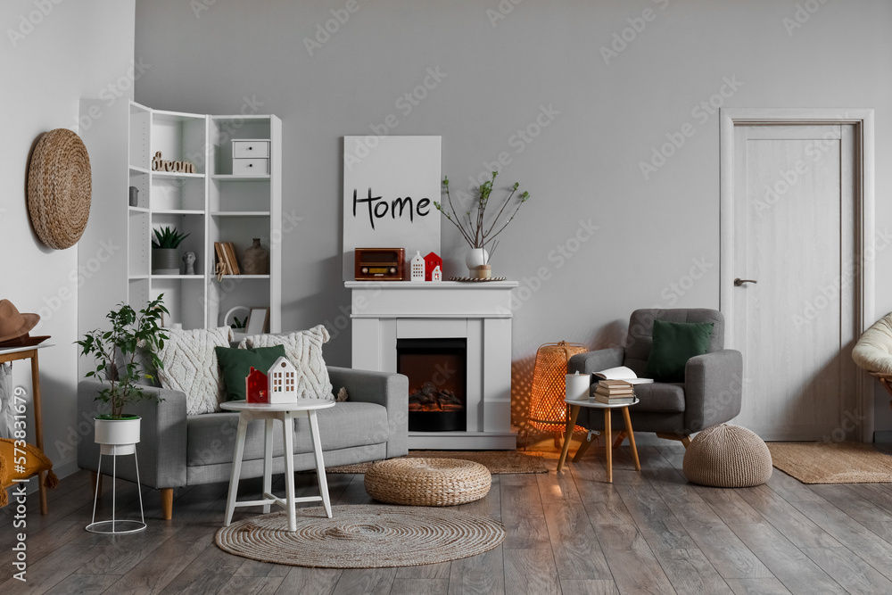 Interior of living room with fireplace, tables and house candle holders