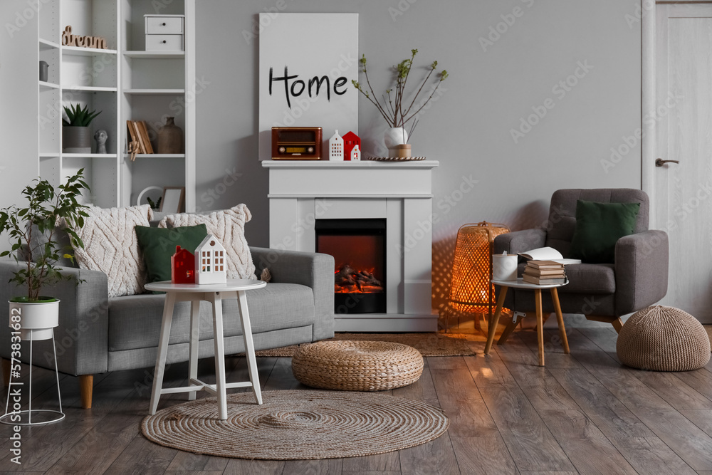 Interior of living room with fireplace, tables and house candle holders