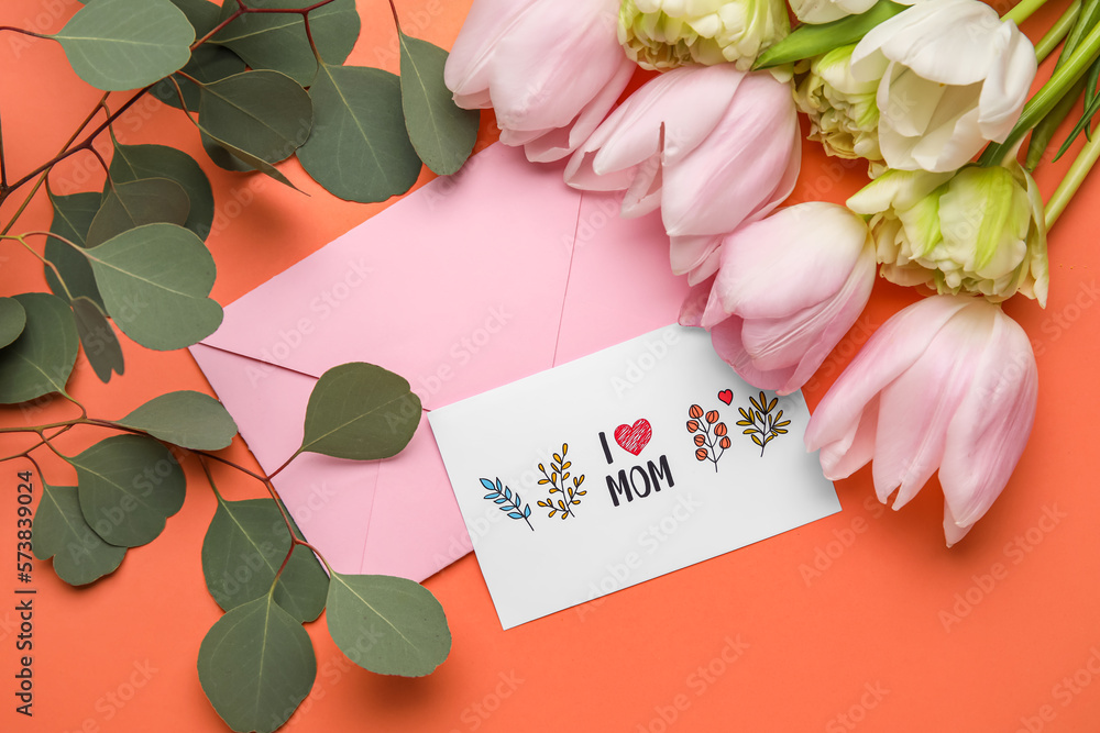 Composition with greeting card, eucalyptus branches and flowers on color background, closeup. Mother