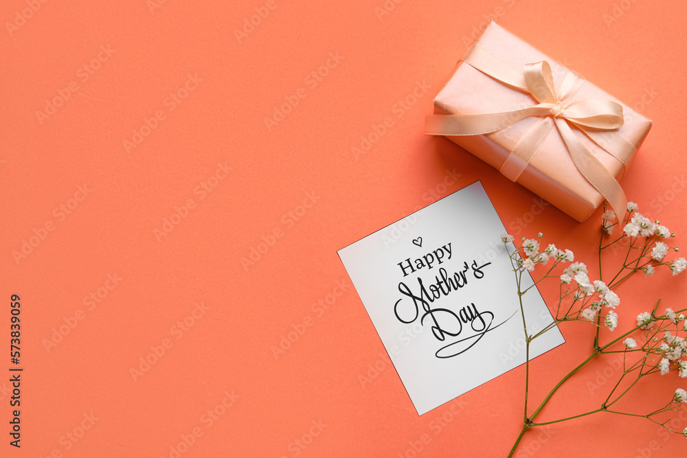 Card with text HAPPY MOTHERS DAY, gypsophila flowers and gift box on color background