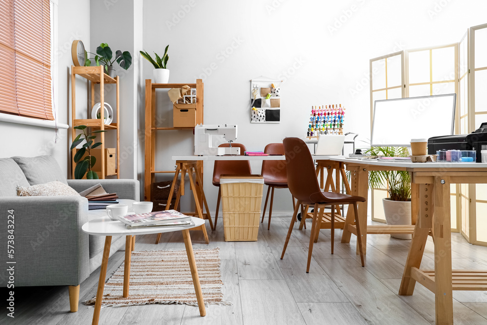 Interior of atelier with tailors workplace and sofa