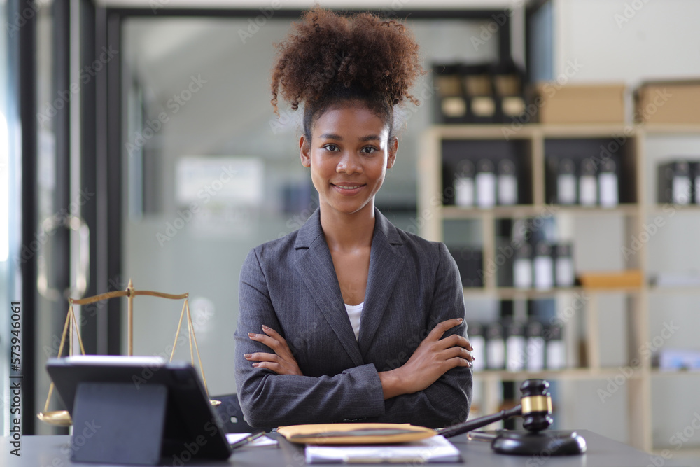 Female lawyer working on a desk in a law office.