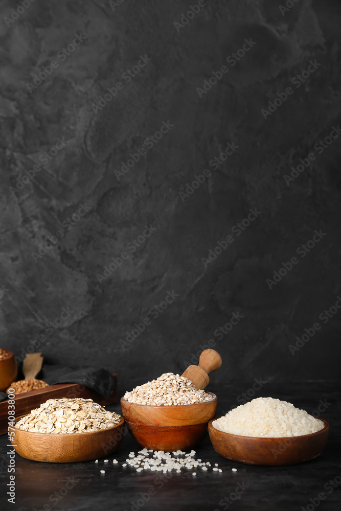 Bowls with cereals on dark background