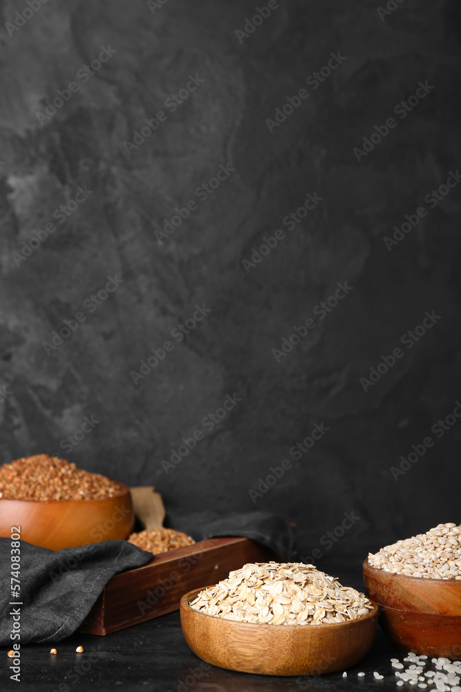 Bowls with cereals on dark background