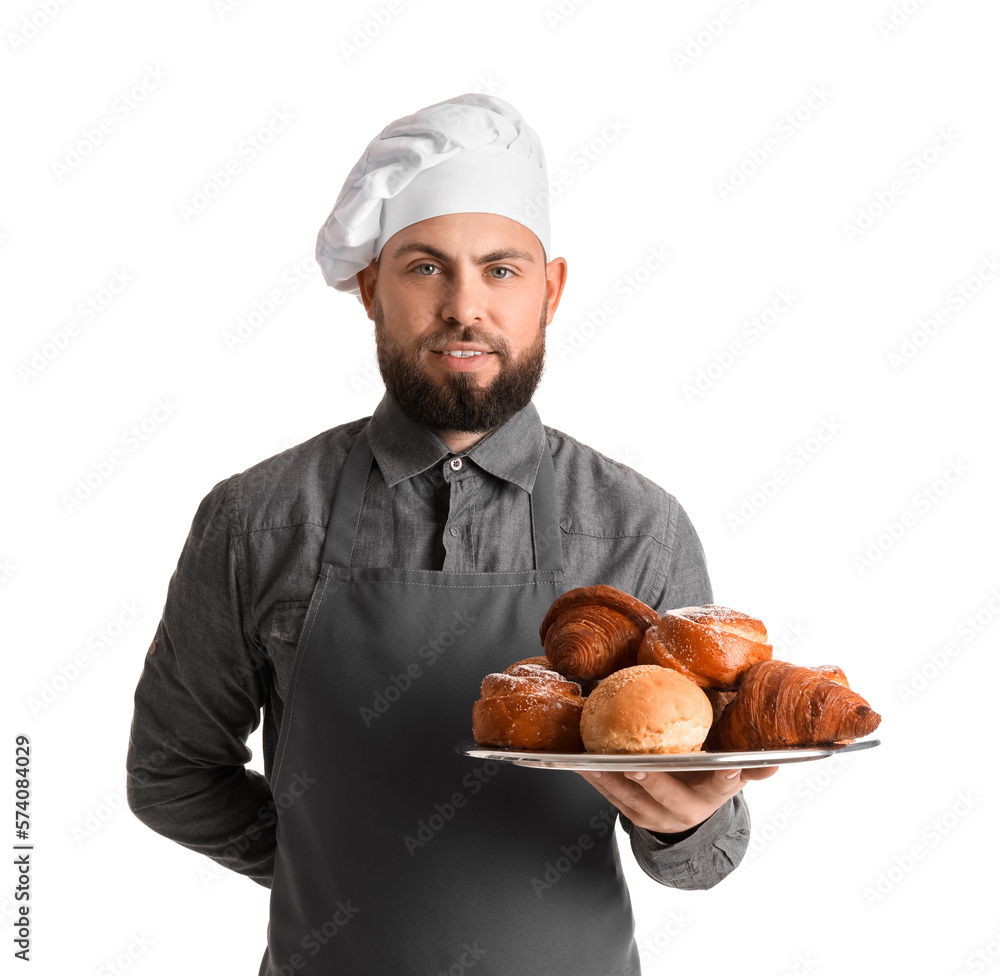 Male baker holding tray with pastries on white background