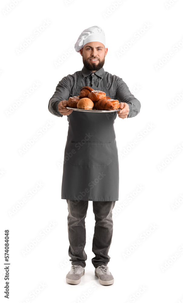 Male baker holding tray with pastries on white background