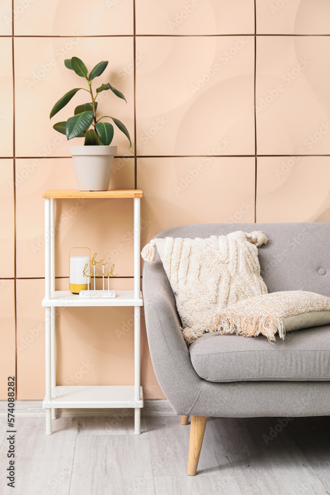 Interior of living room with grey couch and shelving unit