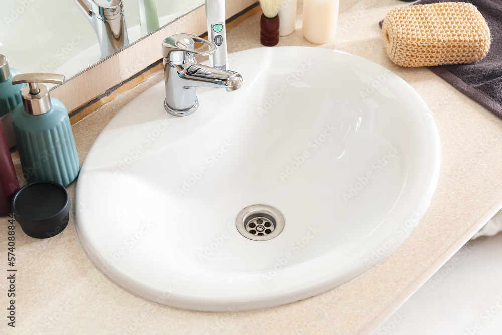 Table with white sink and bath supplies